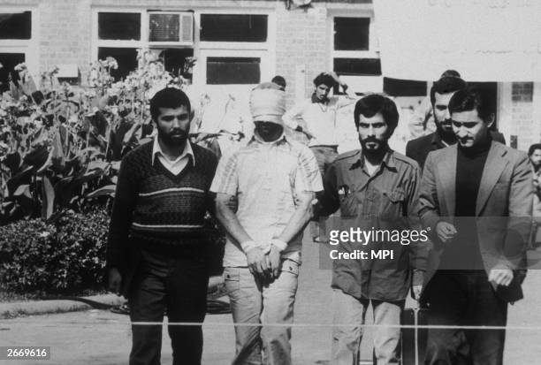 An American hostage being paraded before the cameras by his Iranian captors. Following the Iranian revolution over fifty American hostages were taken...