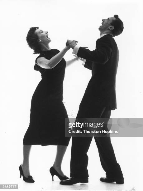 The manager of the Arthur Murray School of Dance in London demonstrates the cha-cha-cha with his wife. Original Publication: Picture Post - 8983 -...