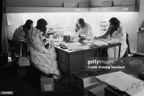 Four women working in an office in Bond Street, London during the power cuts of 1973-74, which were caused by the miners' strike. Luckily for these...