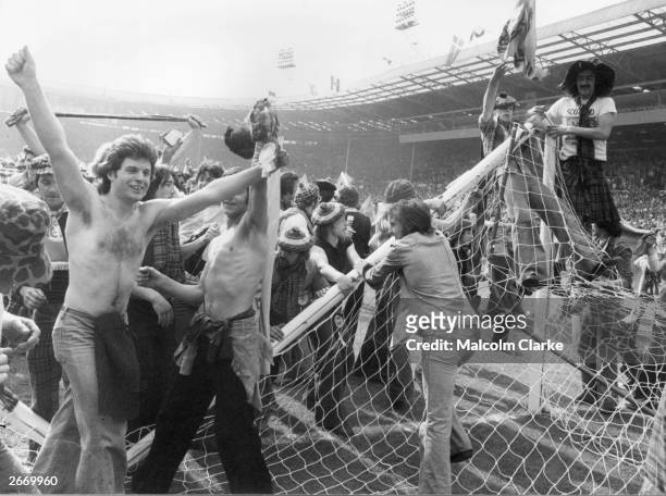 Scottish football fans, known as the Tartan Army, invading the pitch and pulling down goalposts after Scotland beat England 2-1 at Wembley Stadium....