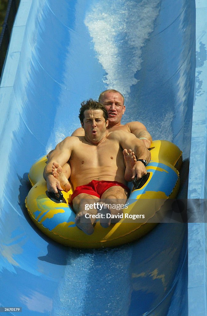  Andy Gomarsall (front) and Neil Back of England enjoy the waterslide...