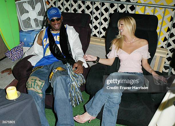 Former NBA player Dennis Rodman and actress Brande Roderick sit on the Sharper Image massage chairs at the 2003 Tall Pony Radio Music Awards gift...