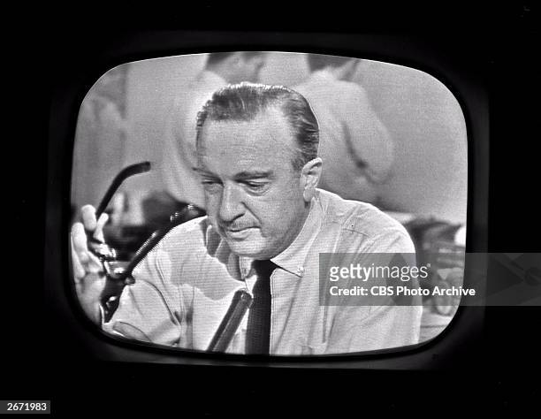 Screen capture of American broadcast journalist Walter Cronkite as he removes his glasses while announcing the death of President John F Kennedy as...