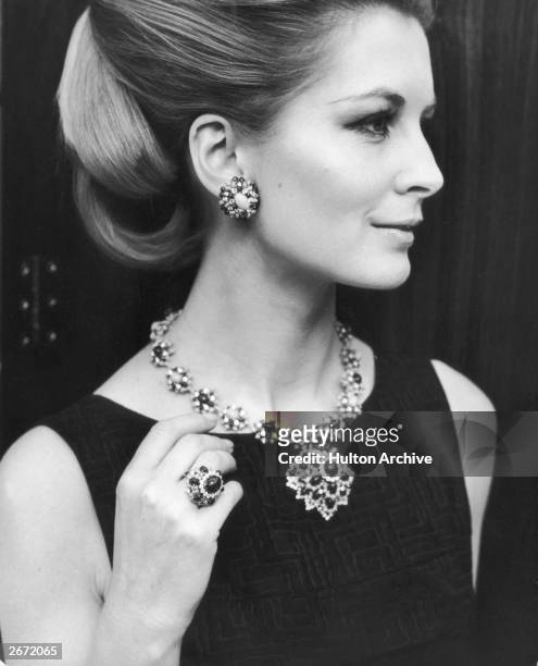 Sandra Paul modelling a lapis turquoise diamond necklace with matching ring, ear-clips and pendant at the opening of jewellery designer David Morris'...