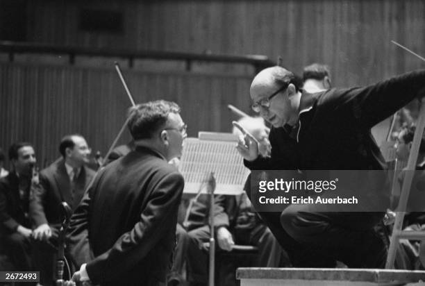 Russian composer and pianist Dmitri Shostakovich , right, discusses his Cello Concerto with German conductor Gennady Rozhdestevensky of the Leningrad...