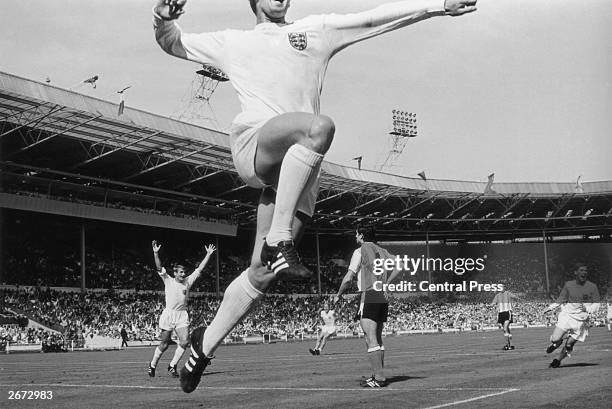 England football player Geoff Hurst jumps in jubilation after scoring England's winning goal against Argentina in the World Cup quarter final match...