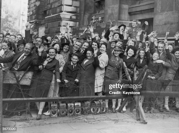 Crowds at Downing Street, London, cheer prime minister Clement Attlee after the surrender of Japan.