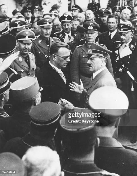 German dictator Adolf Hitler talks to Dr Artur von Seyss-Inquart, the last Chancellor of Austria, after Hitler's speech in the Heldenplatz, Vienna,...