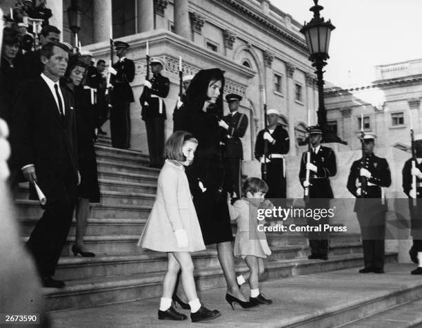 Jackie Kennedy and her children John Jr. And Caroline, walking down steps past a guard of honour at the funeral of President Kennedy. Robert Kennedy...