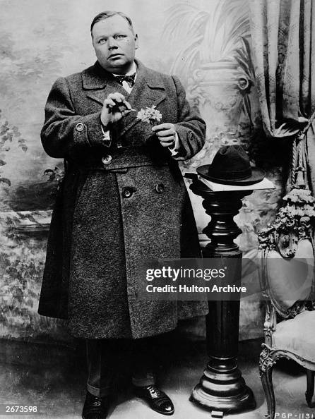 American comic actor Roscoe #39 Fatty #39 Arbuckle picking petals from a American comic actor Roscoe #39 Fatty #39 Arbuckle picking petals from a