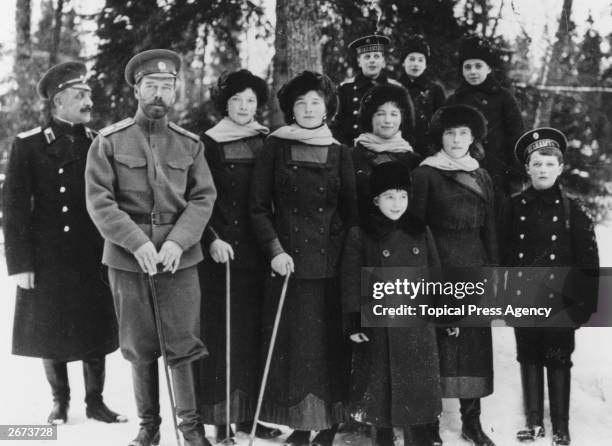 Tsar Nicholas II of Russia with members of his family in the private grounds of Tsarskoe Selo, the summer palace. From left to right: an officer...