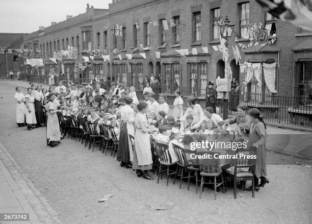 Children's tea party in an East End Street in London, to celebrate the Treaty of Versailles at the end of the First World War.