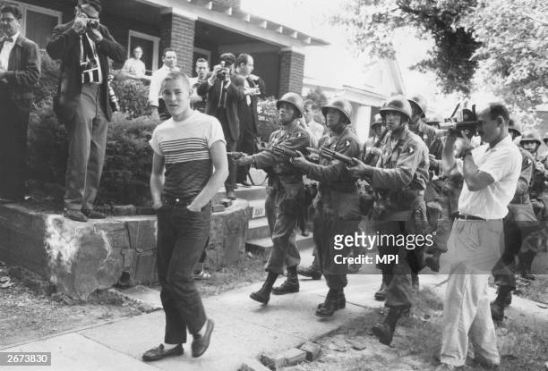 Federal troops confront a racist student from Little Rock Central High School, Arkansas. It took 10,000 of the National Guard to convince white...