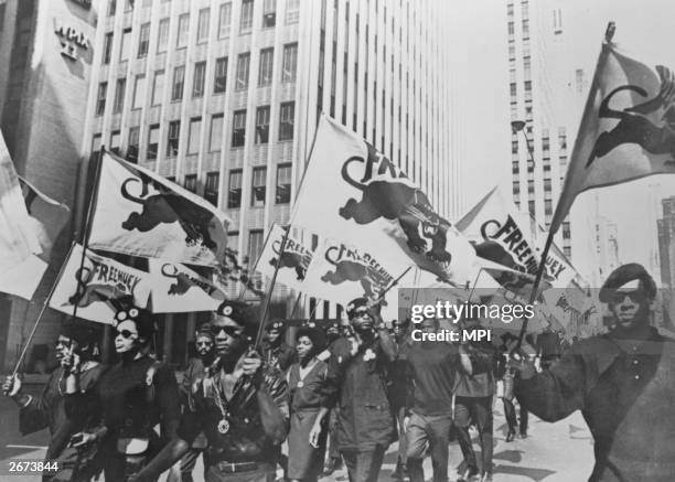 Black Panthers march to a news conference in New York to protest at the trial of one of their members, Huey P Newton. Newton was later convicted for...