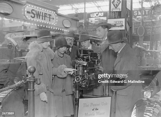 Sir Henry Norman inspecting the Morris Minor's Wolseley engine unit at the 22nd Annual International Motor Show at Olympia, London.