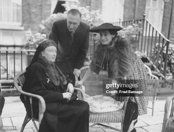 Poetess Edith Sitwell chatting with composer Sir William Walton and his wife Lady Walton during a Royal Society of Literature Garden Party held at...