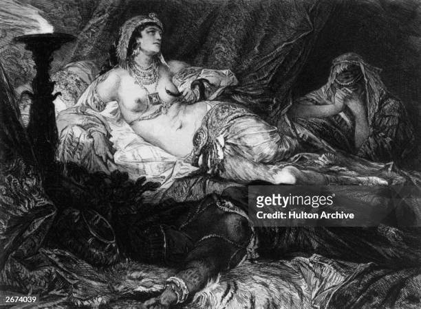 Cleopatra , Queen of Egypt, reclinining on a bed beside a grief-stricken attendant, clutches the asp which she will cause to bite her, thus taking...