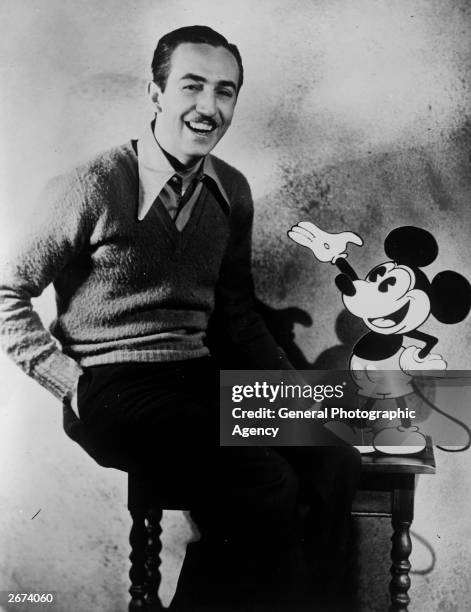 American animator and producer Walt Disney with one of his creations Mickey Mouse.