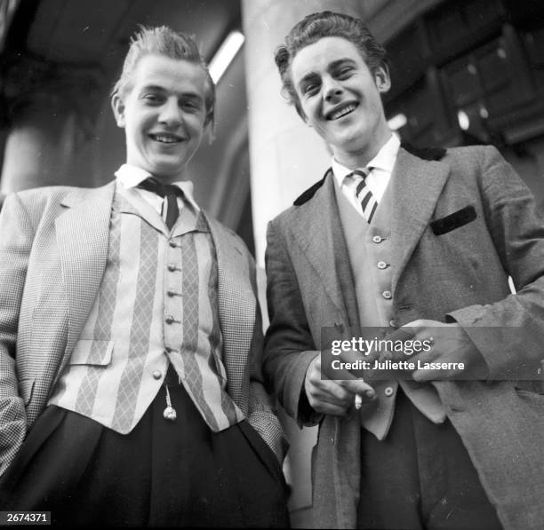 Two Teddy boys, one with striped waistcoat and the other with a velvet collared jacket.