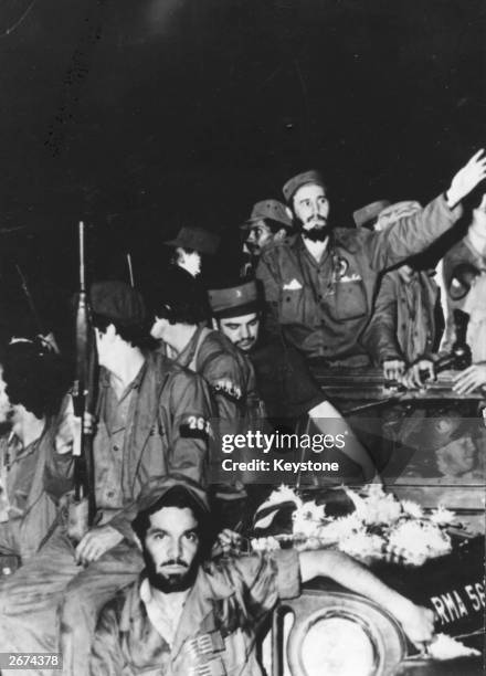 Cuban revolutionary leader Fidel Castro with soldiers of the Rebel Army en route for Havana. He became prime minister in February 1959.