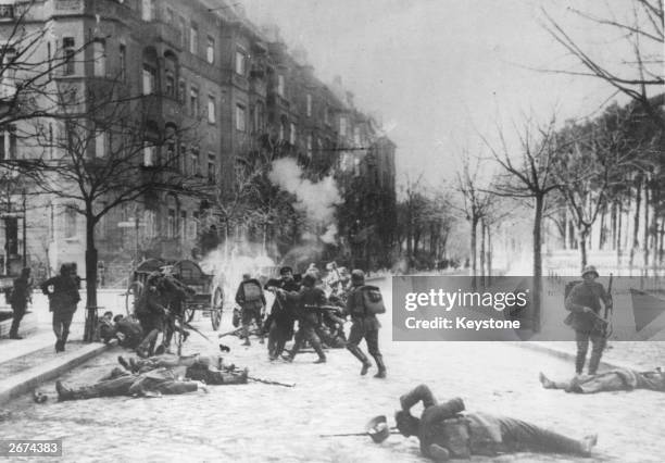 Street fighting in Berlin between Government troops and Spartacists, during the Spartacist uprising which followed Germany's defeat in World War I.
