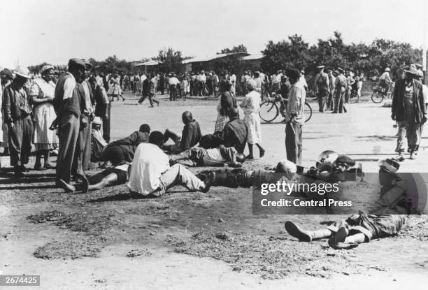 Dead and wounded rioters lying in the streets of Sharpeville, South Africa, following an anti-apartheid demonstration organized by the Pan-Africanist...