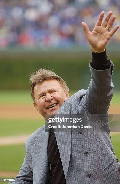 Former Chicago Cub third baseman Ron Santo waves to the fans during a retirement ceremony for Santo's uniform number 10 before a game against the...