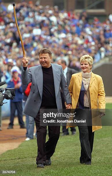 Former Chicago Cub third baseman Ron Santo and his wife Vicki walk onto the field before a retirement ceremony for Santo's uniform number 10 before a...