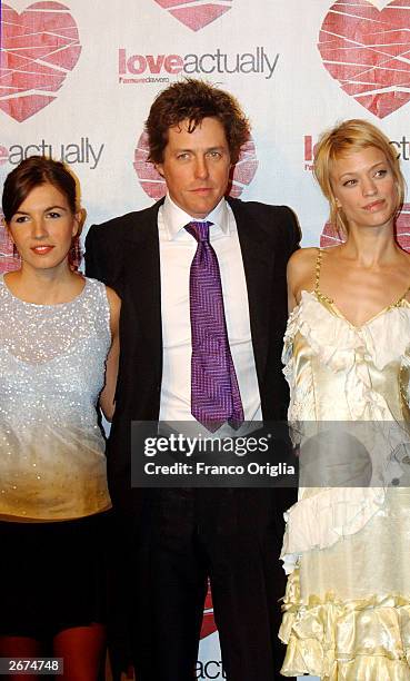 Actress Lucia Moniz, actor Hugh Grant and actress Heike Makatsch arrive at the premiere of his new movie "Love Actually" directed by Richard Curtis...
