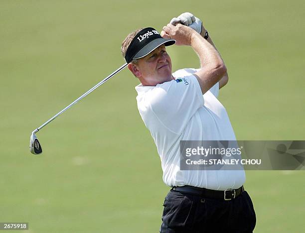 Colin Montgomerie of Scotland hits his shot on the fairway on the 17th during round three of the Macau Open on 18 October 2003 held at the Macau Golf...