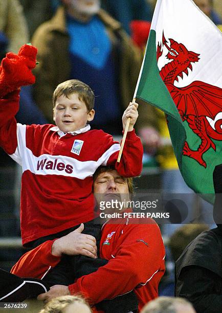 Welsh father and son listen to the national anthem during the Pool D Rugby World Cup 2003 game between Wales and Tonga in Camberra,19 October 2003....