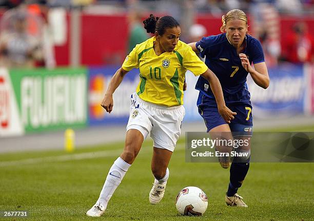 Forward Marta of Brazil is pressured by defender Sara Larsson of Sweden during the 2003 FIFA Women's World Cup quarterfinal match at Gillette Stadium...