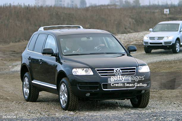 German Chancellor Gerhard Schroeder test drives a Volkswagen Touareg sport utility vehicle October 29, 2003 at the VW factory just outside...