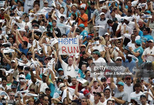 Florida Marlins fans cheer after catcher Pudge Rodriguez of the Florida Marlins hit a home run in the first inning against the San Francisco Giants...