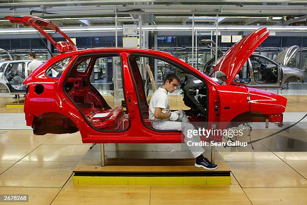 Worker assembles a Volkswagen Polo compact car October 29, 2003 at the Volkswagen factory just outside Bratislava, Slovakia. The factory produces the...