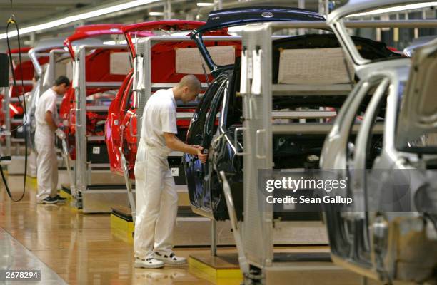 Workers assemble Volkswagen Polo compact cars October 29, 2003 at the Volkswagen factory just outside Bratislava, Slovakia. The factory produces the...