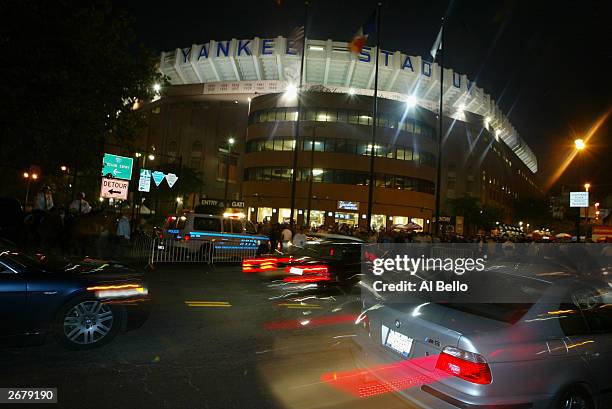 Fans drive past Yankee Stadium before the start of game 1 of the American League Championship Series between the New York Yankee and Boston Red Sox...