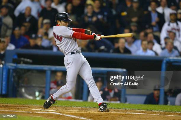 Shortstop Nomar Garciaparra of the Boston Red Sox swings at a New York Yankees pitch during game 1 of the American League Championship Series at...