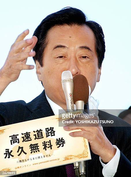 Japan's largest opposition party Democratic Party of Japan leader Naoto Kan shows a free ticket of Japan's expensive expressway as the DPJ expressed...