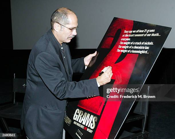 Screenwriter Guillermo Arriaga signs a poster during the Variety Screening Series for the film "21 Grams" at the Arclight Dome Theater on October 29,...