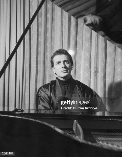 Italian opera singer Franco Corelli at the piano in his house in Milan rehearsing for the 'Compare Turiddu' in the production of Cavalleria Rusticana...
