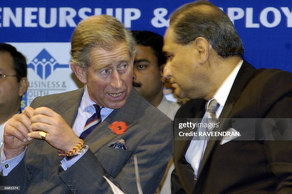 Britain's Prince Charles (L) talks with