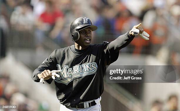 Outfielder Juan Pierre of the Florida Marlins points during Game 2 of the 2003 National League Division Series against the San Francisco Giants at...