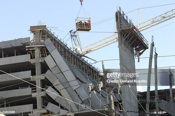 Construction and emergency workers use a lift to try and examine the collapsed decks of a parking garage at the Tropicana Casino and Resort October...