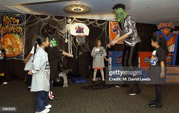 New York Knicks' rookie center, 7'5" Slavko Vranes plays the part of Frankenstein in a skit with a group of students during the New York Knicks Read...