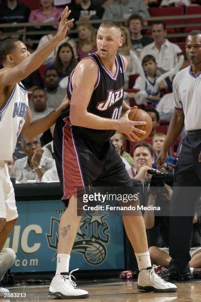 Greg Ostertag of the Utah Jazz posts up against Juwan Howard of the Orlando Magic during the preseason game at the TD Waterhouse Centre on October...