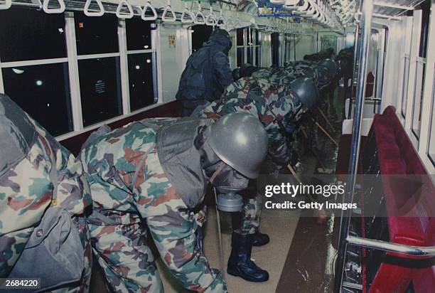 In this handout from the Japanese Defence Agency, personnel of the Self Defence Agency are seen clearing Sarin off platforms after the 1995 Sarin gas...