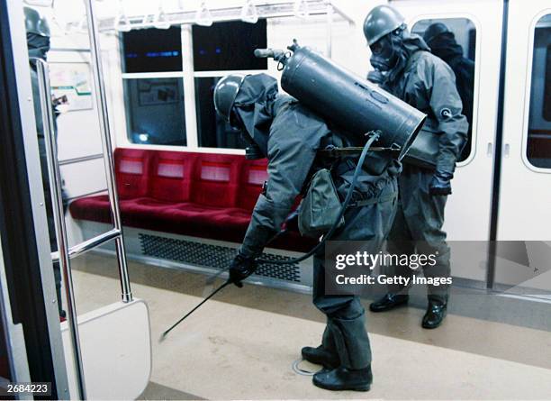 In this handout from the Japanese Defence Agency, personnel of the Self Defence Agency are seen clearing Sarin off platforms after the 1995 Sarin gas...