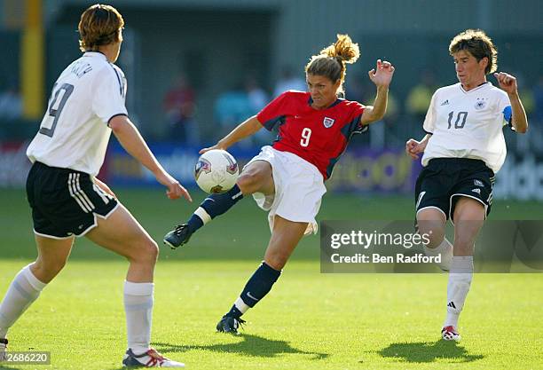 Mia Hamm of the USA kicks against the defense of Germany during the semifinals of the FIFA Women's World Cup match on October 5, 2003 at PGE Park in...