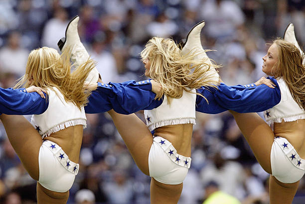 The Dallas Cowboys Cheerleaders perform during the NFL game against the Philadelphia Eagles at Texas Stadium on October 12, 2003 in Irving, Texas....